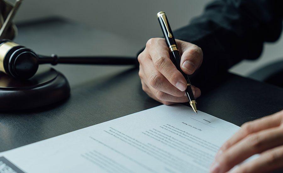 A person signing a document​