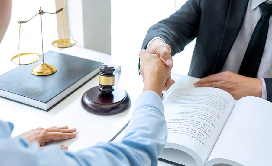 A client shakes hands with a lawyer upon a successful outcome of an arbitration case​